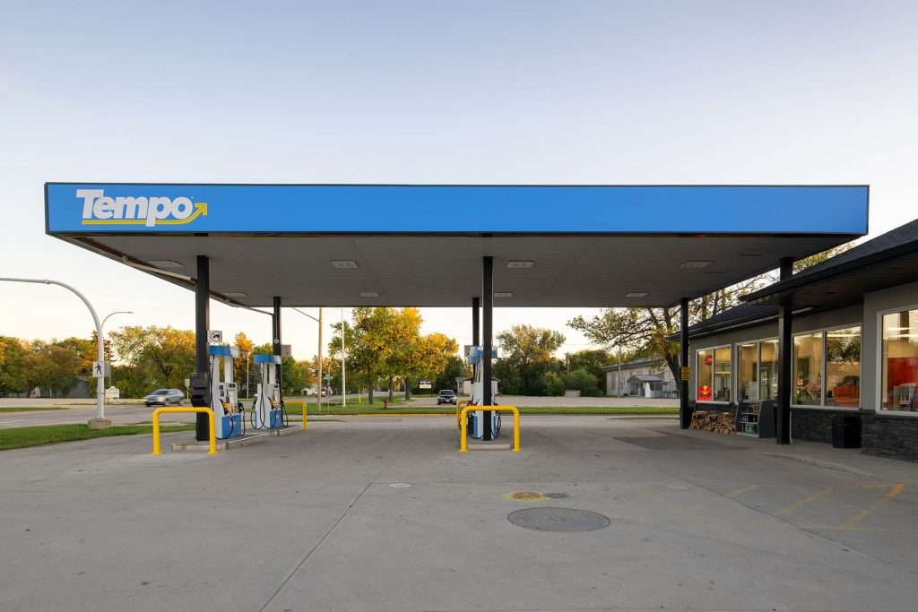 The gas station canopy is a large, metal structure that covers the pumps at the gas station. The canopy protects the pumps from the weather and keeps them in the shade.