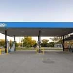 The gas station canopy is a large, metal structure that covers the pumps at the gas station. The canopy protects the pumps from the weather and keeps them in the shade.