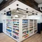 The pharmacy counter is a long, wooden surface that sits against one wall in a pharmacy. It is used to dispense medication to customers.