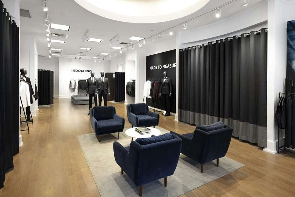 The interior of the indochino store is sleek and modern, with dark wood floors and white walls. Suits in every color and style are displayed on mannequins throughout the store, making it easy for shoppers to find the perfect outfit.