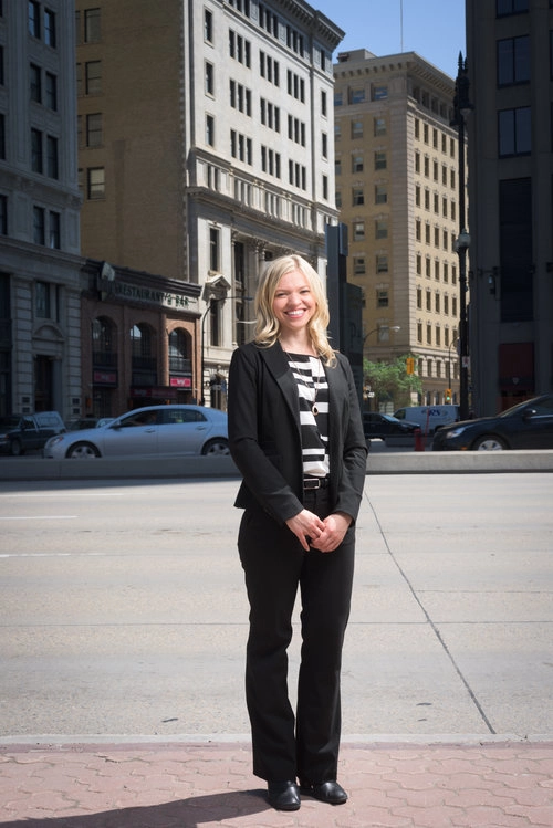 A profile portrait of a female executive with a city background