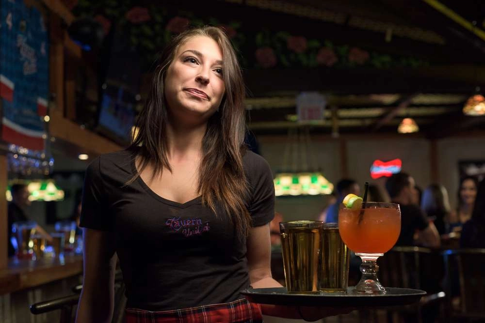 Waitress holding tray of drinks