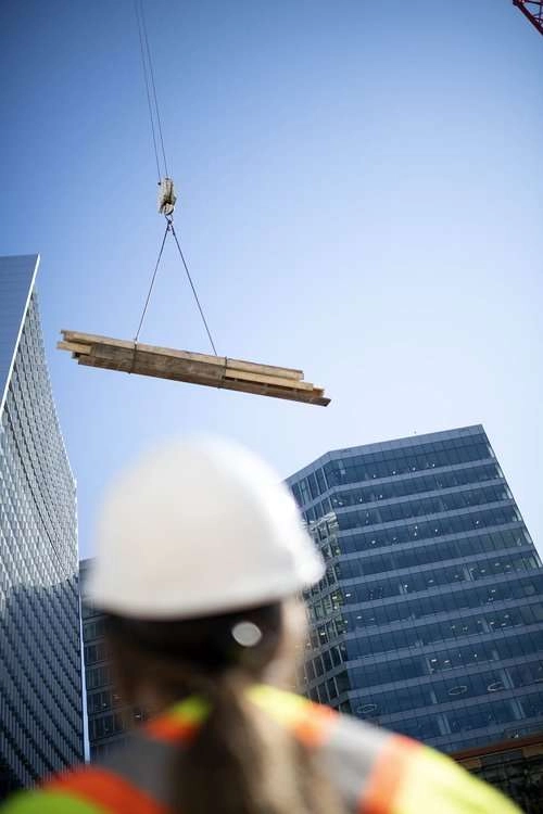 Construction worker watches crane
