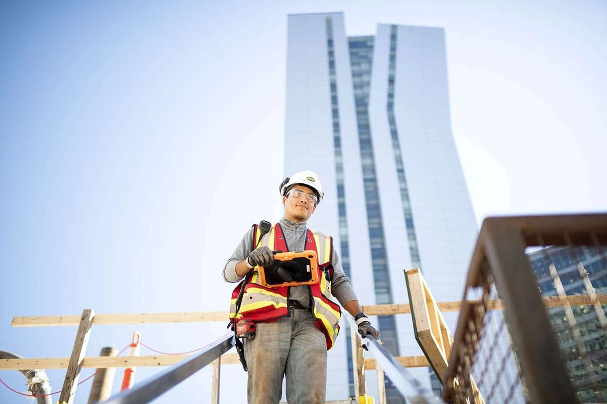 Construction worker with tower in background
