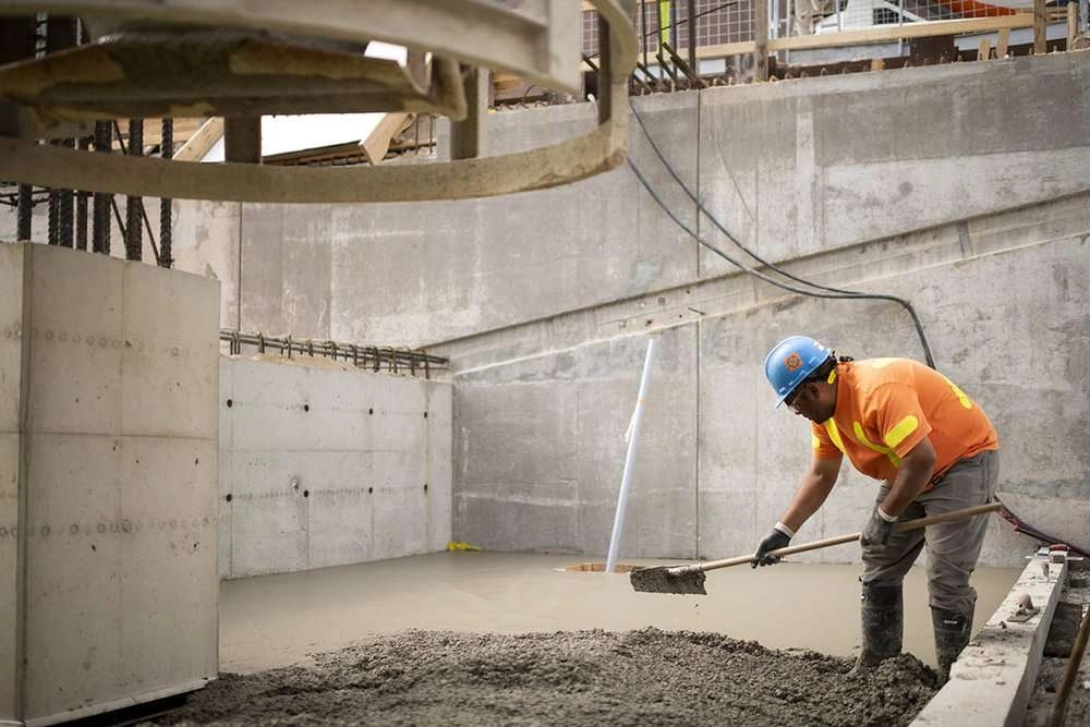 Worker spreads concrete