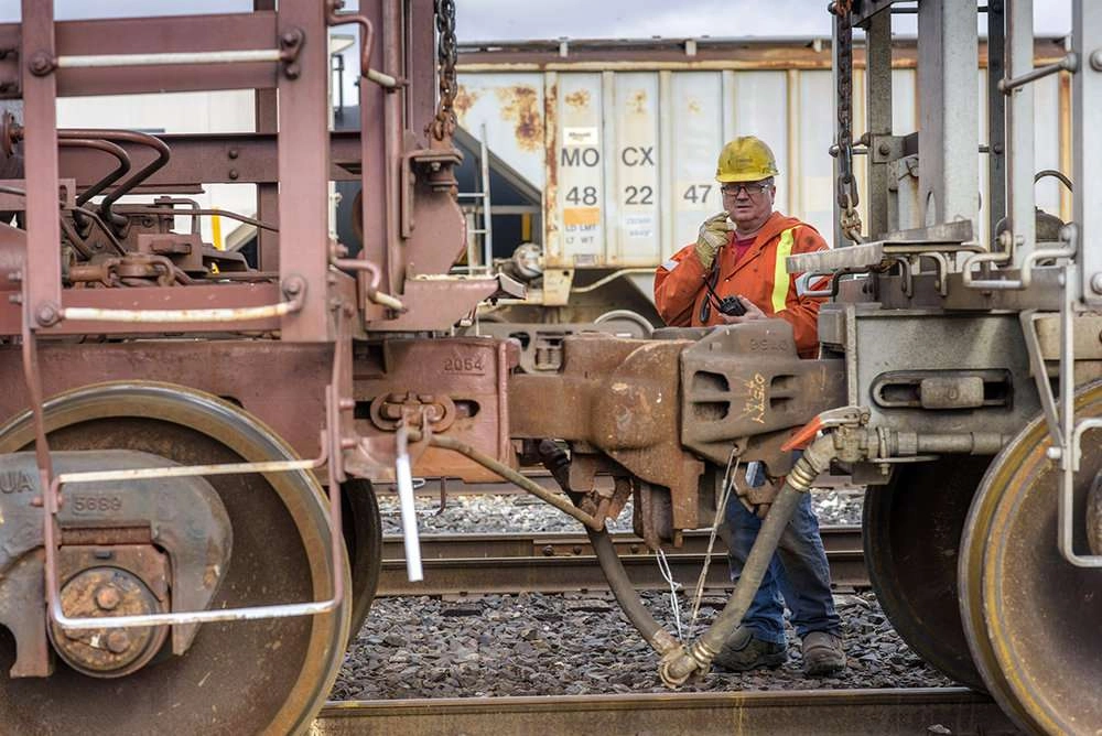 Worker guides rail cars