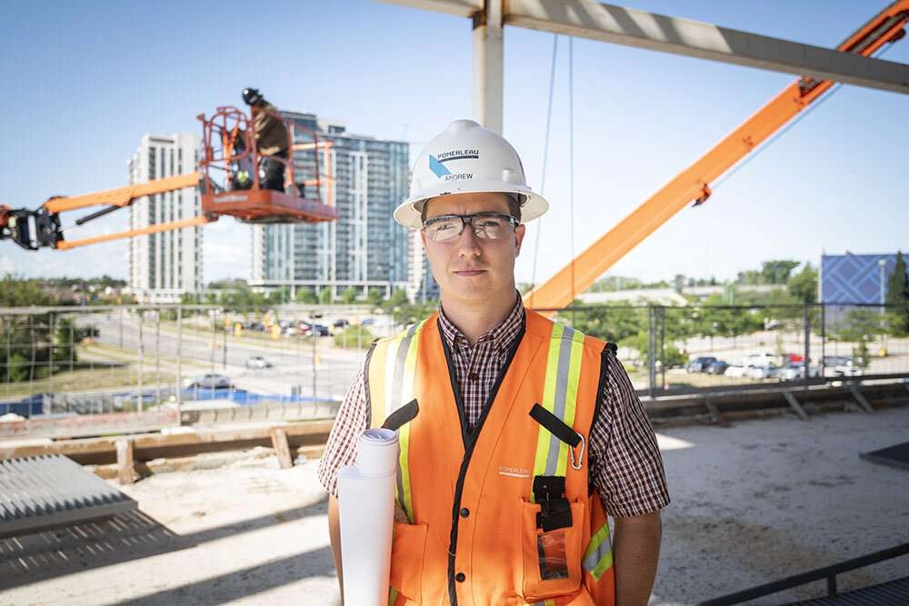 Construction foreman stands for a photo in the job site