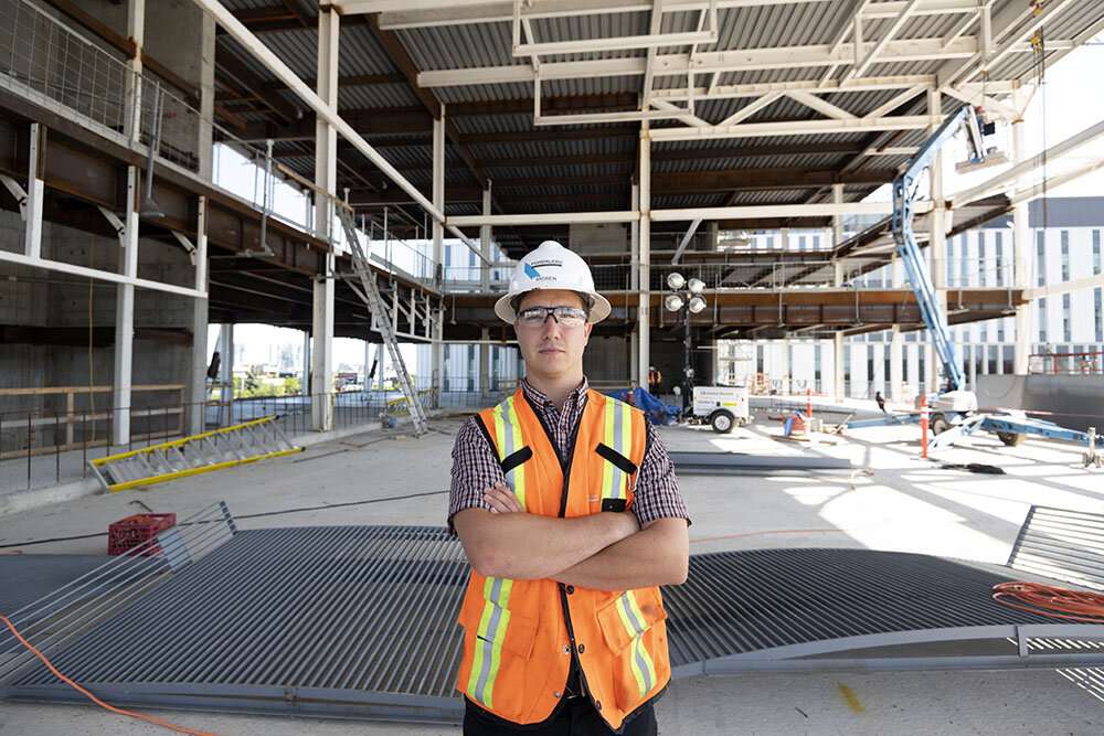 Employee poses for photograph in the center of the job site. ©robert lowdon