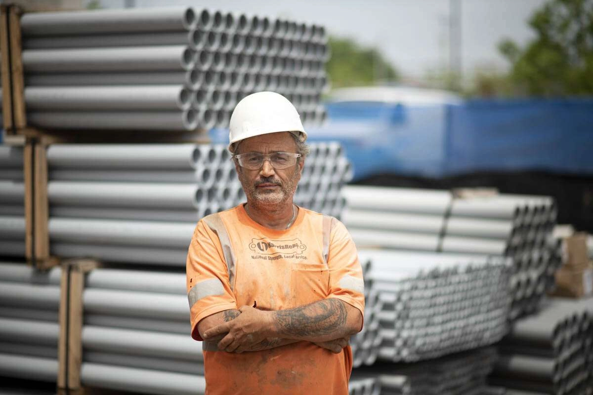 A construction worker in front of various job materials. © robert lowdon