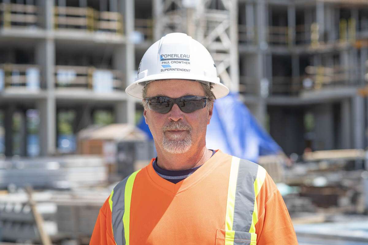 A construction superintendent in front of a job site. © robert lowdon