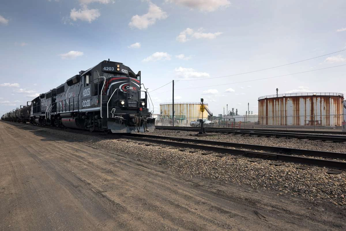 Locomotive moves down track outside oil refinery