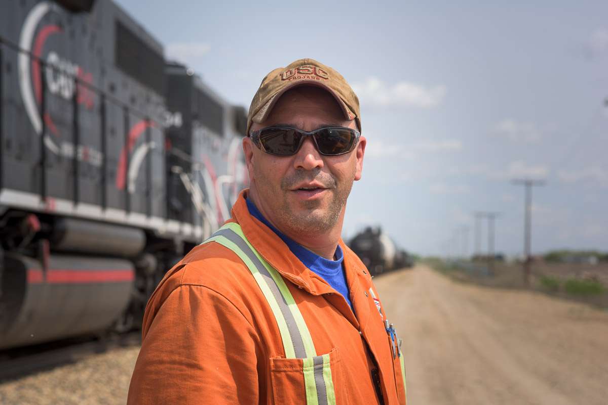 A close-up photo of a crew member. In this stylized photograph, only the employee is in focus.