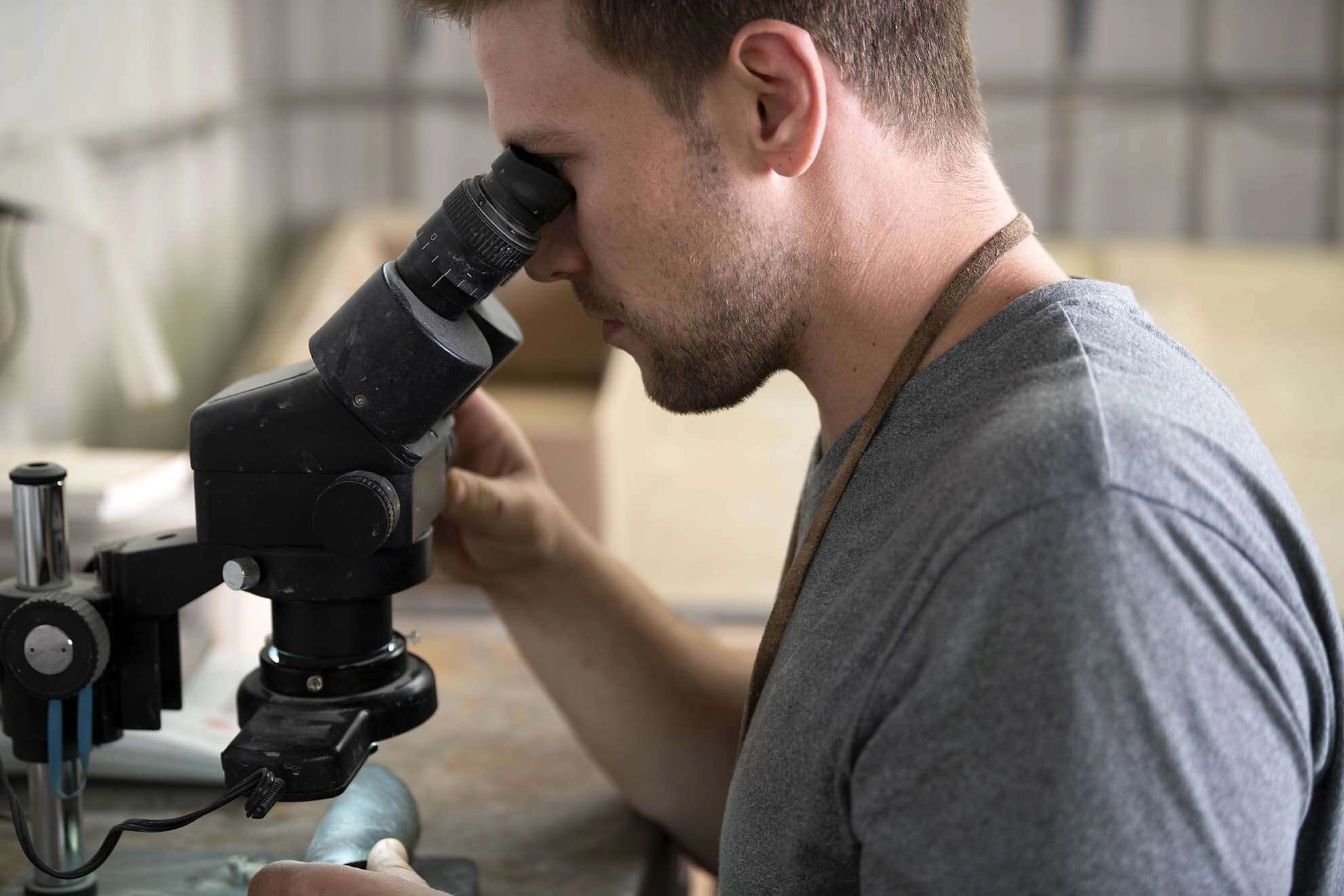 An engineer uses a microscope