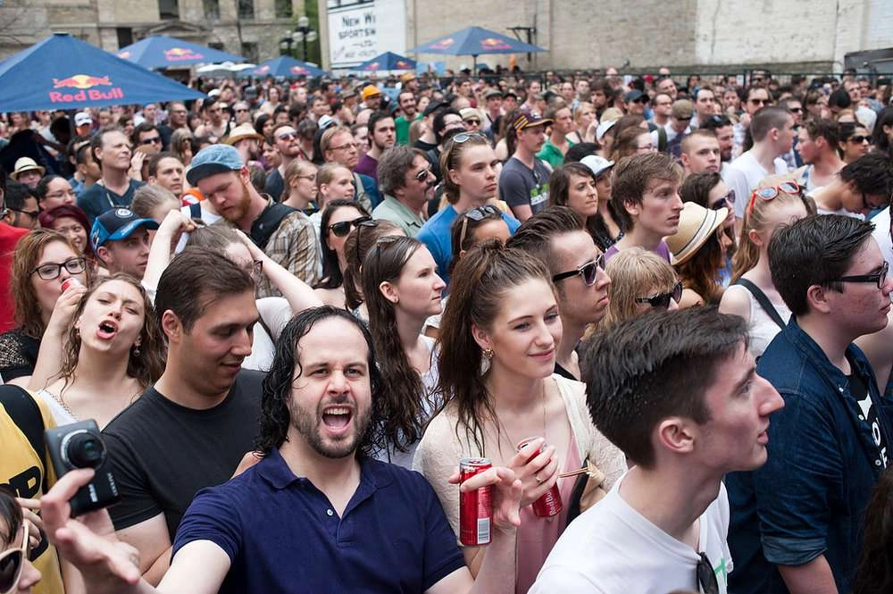 Attendees cheer which red bull as imaginary cities perform at the red bull tour bus hometown tour in winnipeg, canada on may 24th 2014.
