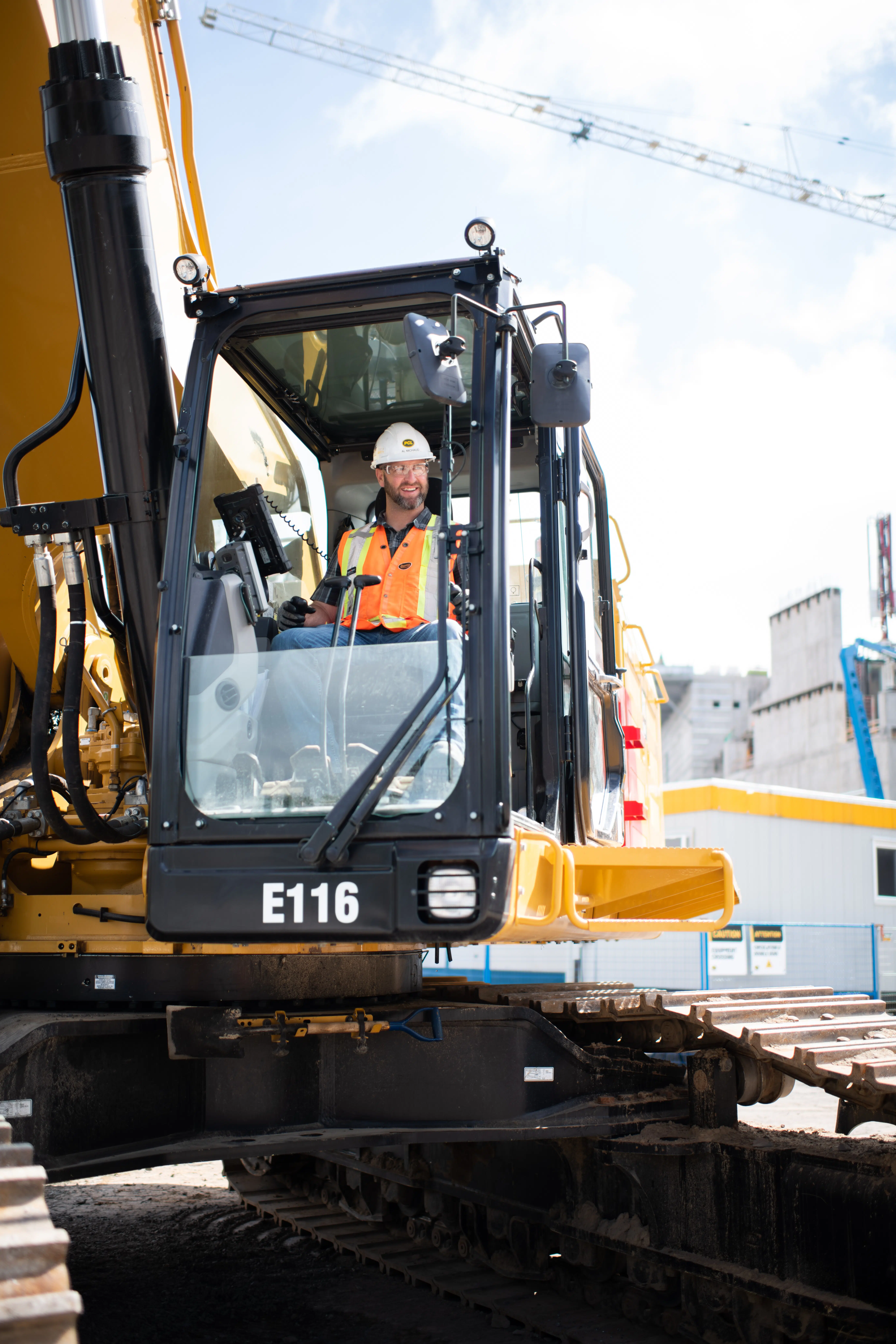 A worker operates a large excavator.