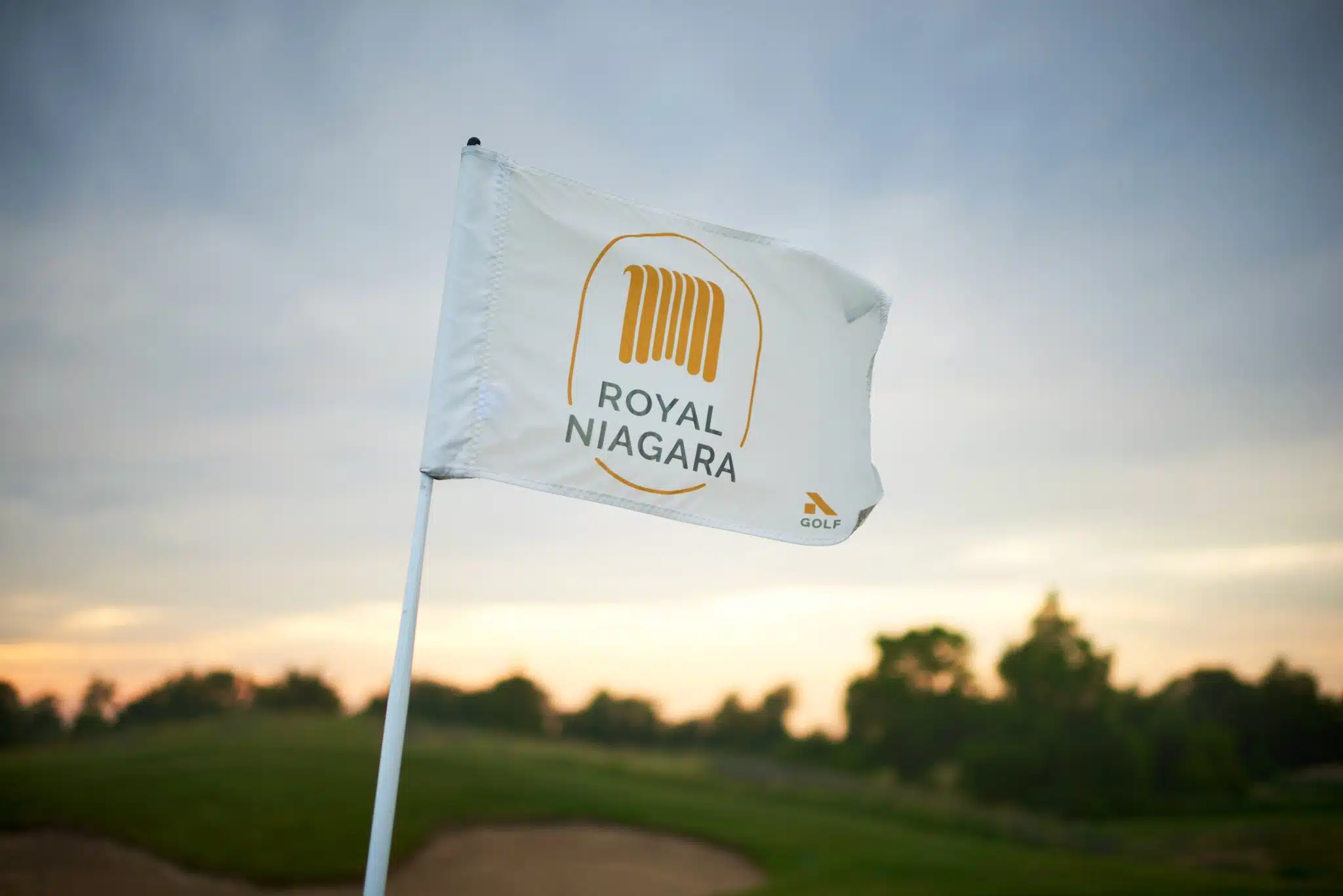 Close up of royal niagara flag in focus, blowing in the wind.