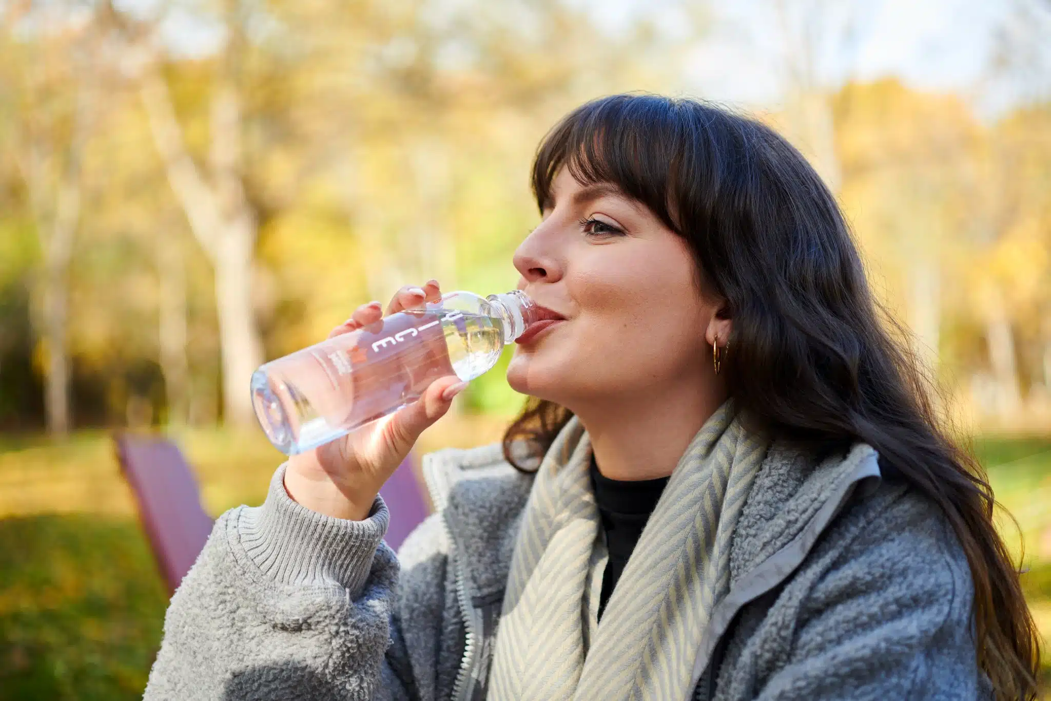 Lifestyle image of model drinking water.
