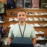 Rebranding image showcasing employee in shoe section of retail store.